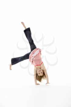 Young Girl In Gymnastic Pose Doing Cartwheel