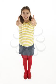 Studio Portrait Of Happy young Girl Giving Thumbs Up Gesture