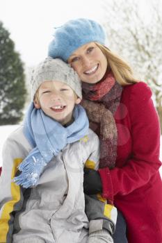 Mother And Son Standing Outside In Snowy Landscape
