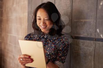 Female Designer In Modern Office Working On Digital Tablet
