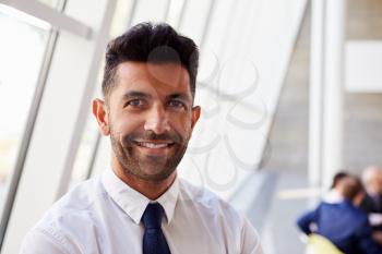 Portrait Of Hispanic Businessman In Modern Office