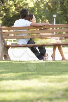 Couple Sitting Together On Park Bench