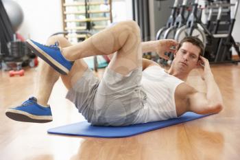 Man Doing Stretching Exercises In Gym