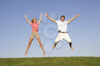 Young couple jumping in air
