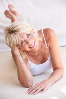 Middle age woman lying down strikes a pose