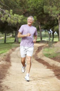 Senior man running in park