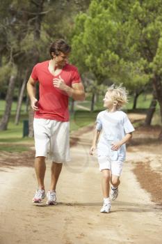 Father and son running in park