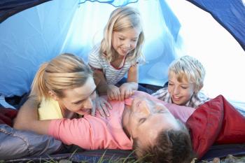 Young family playing in tent