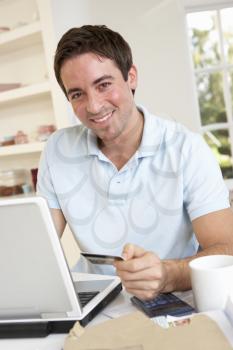 Young man using credit card on the internet