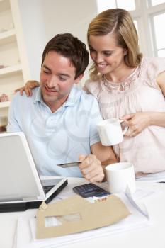 Young couple using credit card on the internet