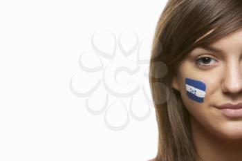 Young Female Sports Fan With Honduras Flag Painted On Face