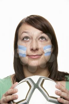 Young Female Football Fan With Argentinian Flag Painted On Face