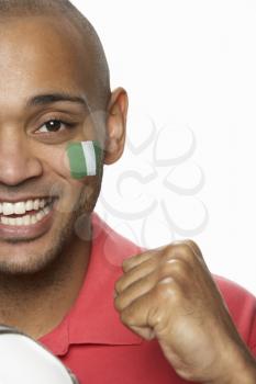 Young Male Football Fan With Nigerian Flag Painted On Face