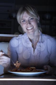 Woman Enjoying Meal Whilst Watching TV