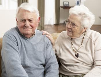 Senior Woman Consoling Husband At Home