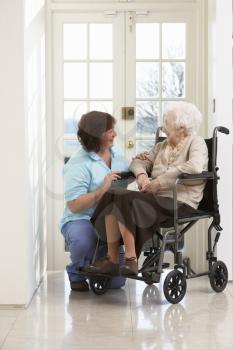 Carer With Disabled Senior Woman Sitting In Wheelchair