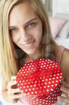 Teenage girl holding gift box