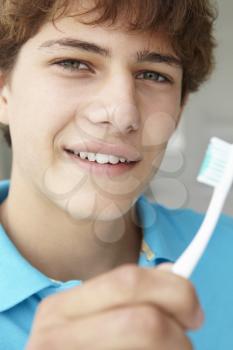 Teenage boy with toothbrush