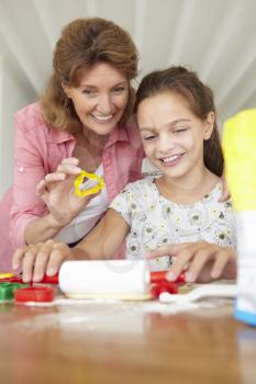 Young girl baking with grandmother