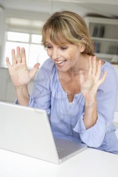 Mid age woman using laptop