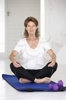 Senior woman sitting in lotus position