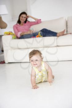 Mother watching baby crawl