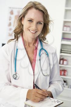 Mid age female doctor writing prescription