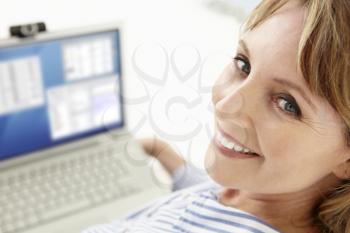 Mid age businesswoman using laptop