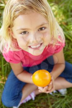 Portrait of happy girl with orange