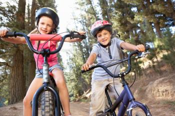 Young children on bikes in country