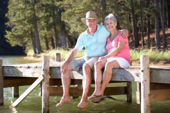 Senior couple sitting by lake
