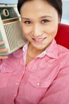Young woman listening to radio