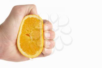 Man's hand squeezing lemon