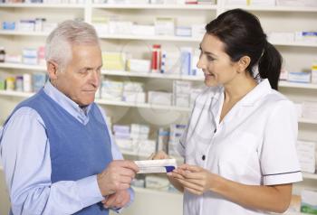 American pharmacist serving  senior man in pharmacy