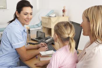 British nurse talking to young child and mother