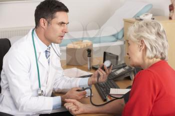 American doctor taking senior woman's blood pressure