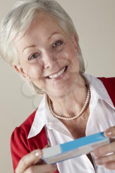 Senior woman holding prescription drug pack