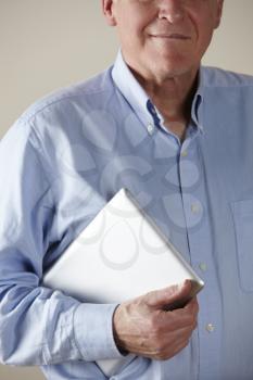 Senior man holding tablet