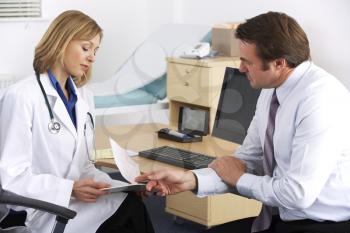 American doctor talking to businessman patient