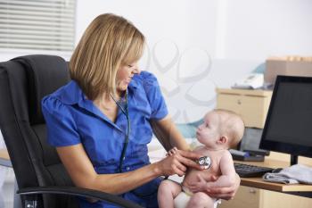 UK doctor examining baby