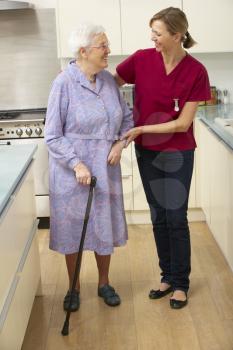 Senior woman and carer in kitchen