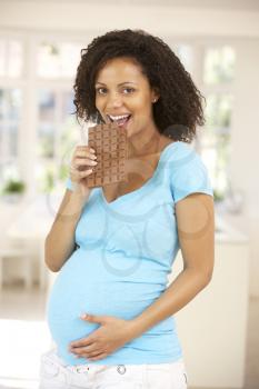 Pregnant woman eating chocolate