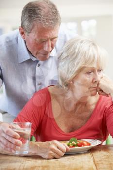 Senior man looking after sick wife