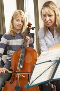 Girl playing cello in music lesson