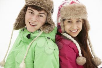Portrait Of Teenage Couple In Snow Wearing Fur Hats