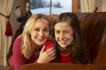 Portrait Of Mother And Daughter Relaxing On Sofa Together