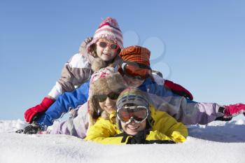 Group Of Children Having Fun On Ski Holiday In Mountains