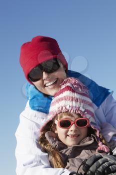 Mother And Daughter Having Fun On Ski Holiday In Mountains
