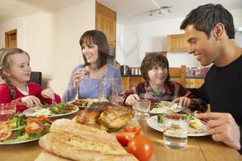 Family Eating Lunch Together In Kitchen