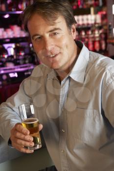 Man Enjoying Drink At Bar